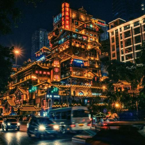 a large building with lights on it at night at Pilot Hotel in Chongqing