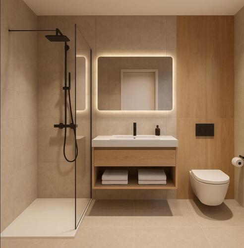 a bathroom with a sink and a toilet and a shower at Apartmenthaus Gilden 7 in Borken