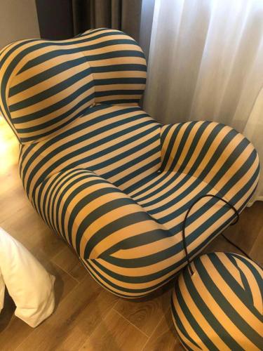 a ottoman sitting on the floor next to a window at Pilot Hotel in Chongqing