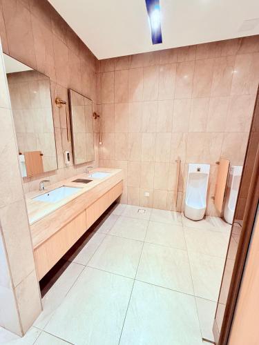 a bathroom with a tub and a toilet and a sink at Luxury Axon Residence Bukit Bintang KLCC 2 Minutes Walking PAVILION in Kuala Lumpur