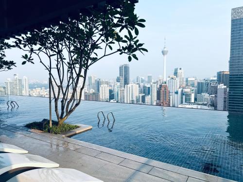 a swimming pool with a city skyline in the background at Luxury Axon Residence Bukit Bintang KLCC 2 Minutes Walking PAVILION in Kuala Lumpur
