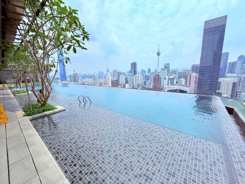 a swimming pool with a city skyline in the background at Luxury Axon Residence Bukit Bintang KLCC 2 Minutes Walking PAVILION in Kuala Lumpur