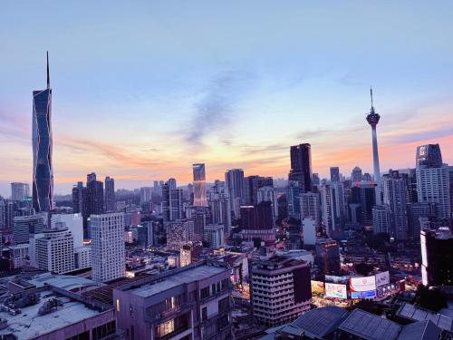 a view of a city skyline at sunset at Luxury Axon Residence Bukit Bintang KLCC 2 Minutes Walking PAVILION in Kuala Lumpur