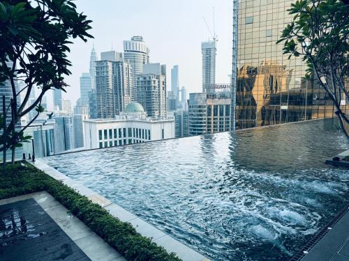 a swimming pool on the roof of a building at Luxury Axon Residence Bukit Bintang KLCC 2 Minutes Walking PAVILION in Kuala Lumpur