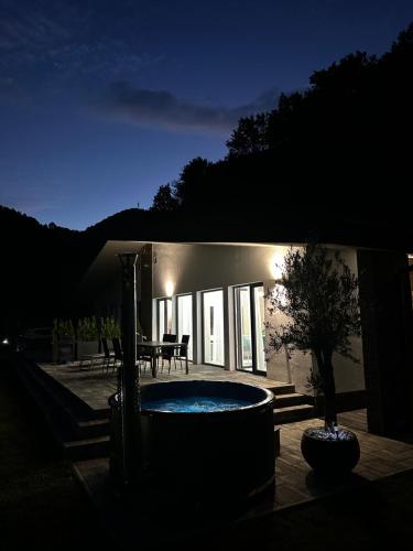 a building with a pool in front of it at night at Podhorský Apartmány Terchová in Terchová
