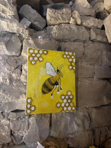 a painting of a bee on a stone wall at B&B Mila in Oprtalj