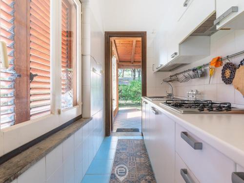 a kitchen with white counters and a stove top oven at Donatella's Sea Haven in Fort Village