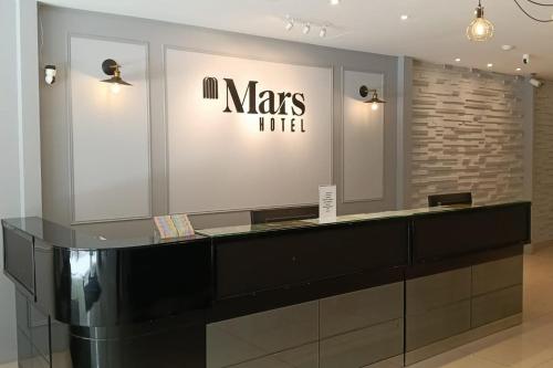 a dressing room with a black counter and a mirror at Mars Hotel in Kuala Lumpur