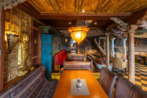 a dining room with a wooden table and chairs at Hotel Nautilus in Putbus