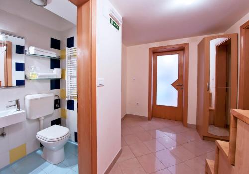 a bathroom with a toilet and a sink at MalAna in Zaton