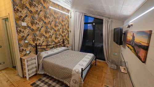 a bedroom with a bed and a tv in a room at A Casa di Alice Assisi in Santa Maria degli Angeli
