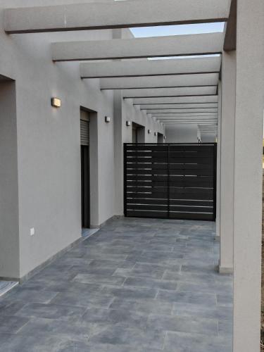 a hallway of a building with a metal gate at Olympic Flame Suites in Pýrgos