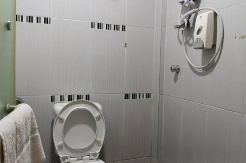 a bathroom with a toilet and a mirror at Mars Hotel in Kuala Lumpur