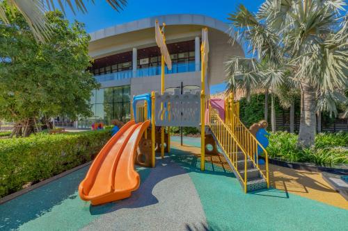 a playground with a slide in front of a building at Wyndham Grand KN Paradise Cam Ranh in Cam Ranh