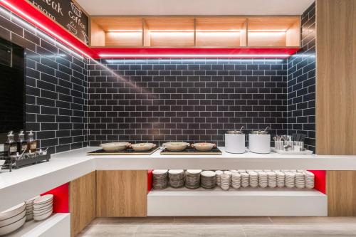 a kitchen with a counter with plates and food at Ibis Huangshan Scenic Area Hotel in Huangshan Scenic Area