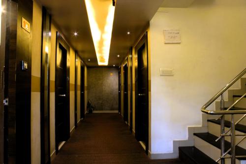 a hallway with stairs and elevators in a building at New Rekha Residency in Bengaluru
