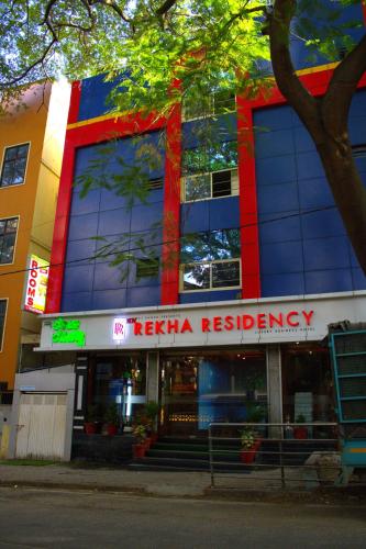 a hospital building with a healing emergency sign on it at New Rekha Residency in Bengaluru