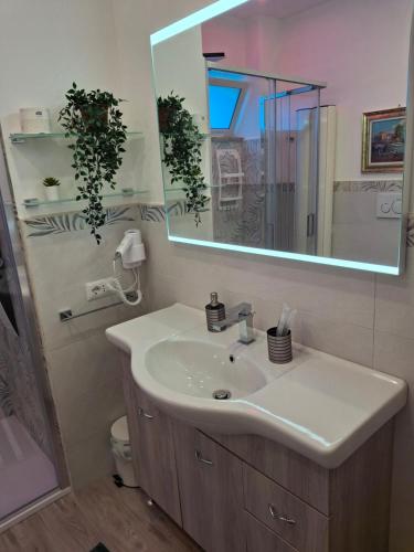 a bathroom with a sink and a mirror at B&B Brezza Marina in Roccalumera
