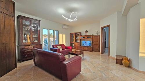a living room with a couch and a table at Tenute D'Angelo - Holidays, Relax & Wellness - Casa vacanze ad Agrigento in Agrigento