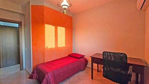 a bedroom with a bed and a desk and a chair at Tenute D'Angelo - Holidays, Relax & Wellness - Casa vacanze ad Agrigento in Agrigento
