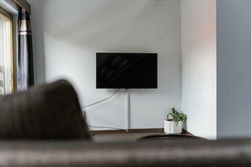 a living room with a flat screen tv on a wall at Niki Apart Pension in Gheorgheni