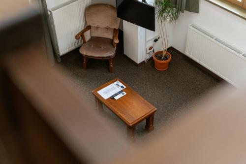 an overhead view of a living room with a table and a chair at Niki Apart Pension in Gheorgheni