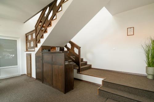 a staircase in a room with a stair case at Niki Apart Pension in Gheorgheni