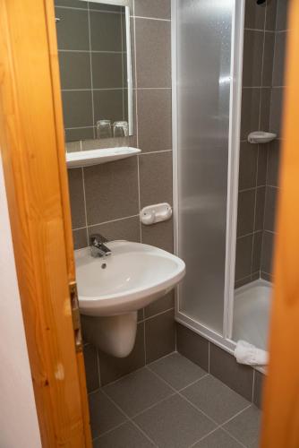 a bathroom with a sink and a shower at Castrum Camping & Pension in Hévíz