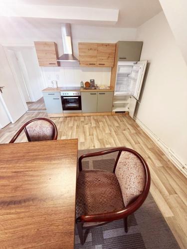 a kitchen with a table and chairs in a room at Landhaus Herdt in Lauda-Königshofen