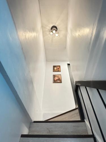 a staircase in a building with two pictures on the wall at Unique Vibes Staycation in Punta