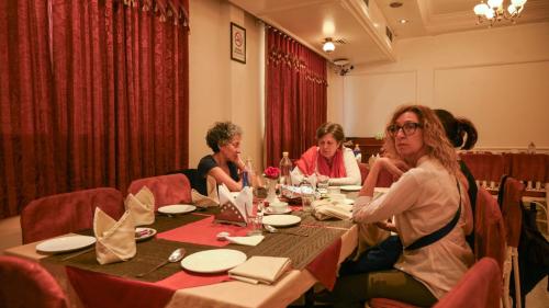 a group of people sitting at a table at Hotel Pradeep in Varanasi