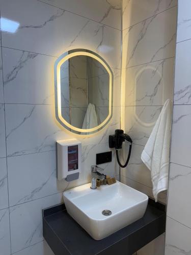 a bathroom with a sink and a mirror at Royal Sevens Otel in Ipekyolu