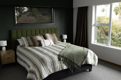 Crayfish Creek Farm Stay : غرفة نوم بسرير اخضر ومخدات ونافذة