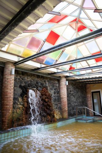 a pool of water in a building with a glass ceiling at Hotel San Valentino Terme in Ischia