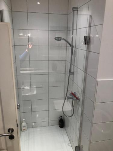 a shower with a glass door in a bathroom at Bright & friendly flat in downtown Duisburg - "Miner Mates Home" from revierquartier boutique apartments in Duisburg