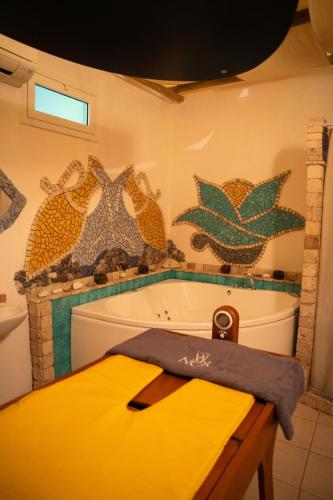a bathroom with a tub and a yellow counter at Hotel San Valentino Terme in Ischia