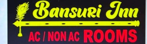 a sign for a restaurant with a yellow and pink writing at Bansuri inn in Mathura