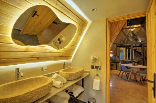 a bathroom with two sinks and a large mirror at The Ranch Camp in El Karia
