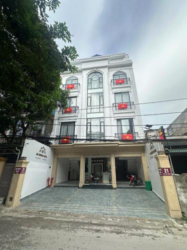 a large white building with a courtyard in front of it at An Dương Hotel in Lạng Sơn