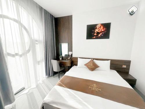 a hotel room with a bed and a window at An Dương Hotel in Lạng Sơn