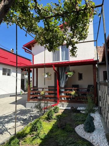 a house with a red roof at Casa Cu Vie in Topliţa