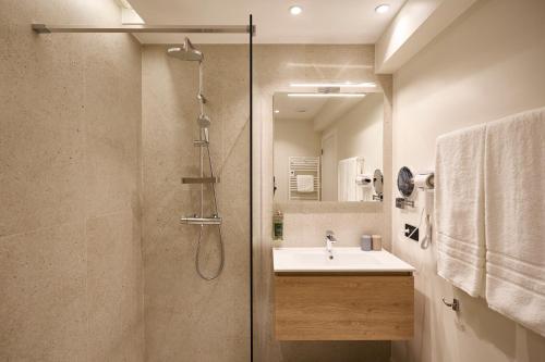 a bathroom with a shower and a sink at Georges Henri Aparthotel in Brussels