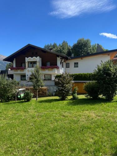 a house with a green lawn in front of it at Martinshof Ladis in Ladis