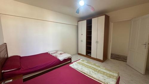 a bedroom with a bed and a closet in it at Panoramic see view apartment in North Coast الساحل الشمالي in Alexandria