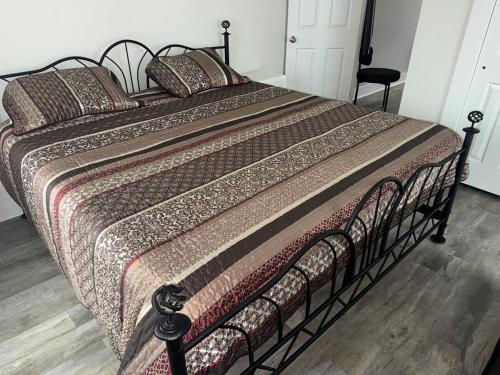 a large bed in a bedroom with a bedspread and pillows at Downtown Willoughby historical district Gem 4 in Willoughby
