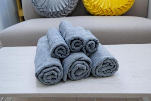 a pile of towels sitting on top of a table at Cruise Inn Kitasenju Station Front1 in Tokyo