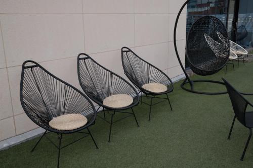 a group of three chairs sitting in a room at 호텔 인썸니아 Hotel Insomnia 失眠酒店 in Daegu