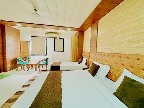 a bedroom with a bed and a table and a couch at Hotel Nysha Delhi in New Delhi