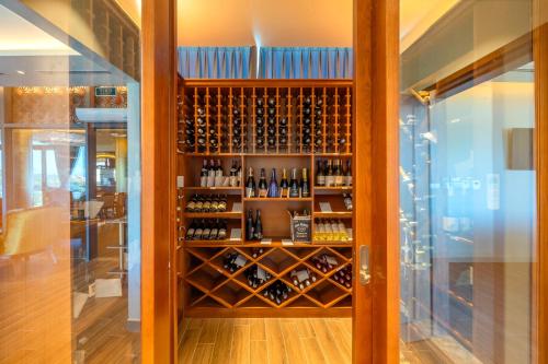 a wine cellar with a shelf of wine bottles at Wyndham Grand KN Paradise Cam Ranh in Cam Ranh
