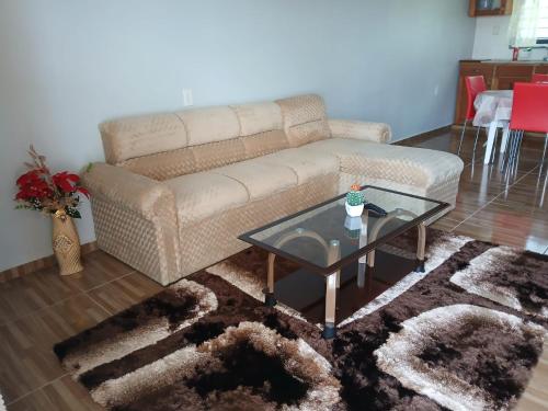 a living room with a couch and a table at Maitidi Place in Paramaribo